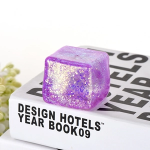 Glittery purple ice cube squishy toy with gold sparkles for stress relief and sensory play