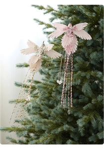 Detailed view of pink hummingbird Christmas ornament with pearls and elegant tassels
