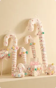 Detailed view of festive plush ornaments including candy canes and gingerbread men