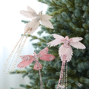 Pink fabric hummingbird ornaments with sequins on Christmas tree branch decoration
