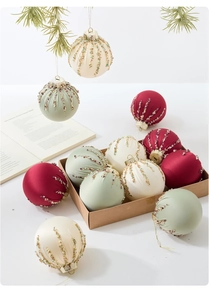 Detalle de bolas de Navidad de terciopelo rojo y verde con acabado de seda y cuentas