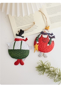 Detail of vintage hand-painted metal snowman ornaments with festive rustic textures