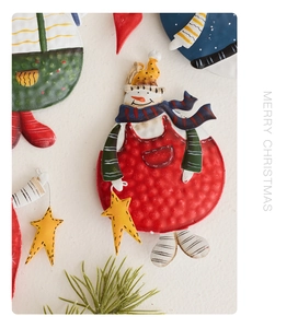 Macro shot of embossed vintage snowman ornament made of hand-painted iron material