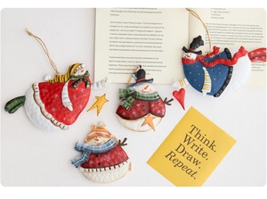 Set of four vintage hand-painted metal snowman ornaments with rustic jute hanging ropes