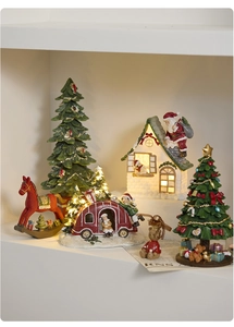 Detailed view of LED lighted resin Christmas miniature set with house and rocking horse