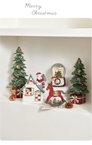 Macro view of Christmas resin decoration set with miniature tree and Santa house decor
