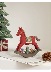 Detail of red Christmas rocking horse ornament with resin texture and gift box accents