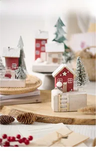 Detail of wooden Christmas snow house miniature set with red cabin and tiny snowman