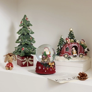 Luminous Christmas resin figurines featuring Santa, snow globe, RV, and teddy bear decor