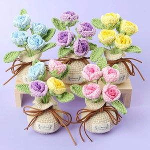 Close-up of five handmade crochet rose flower pots with HandMade with Love tags