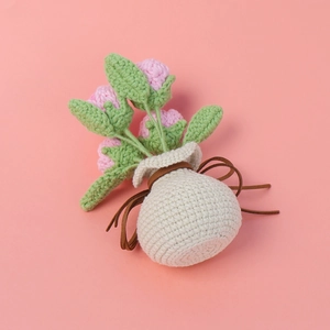 Handmade crochet pink rose flower arrangement in a cream woven pot for home decor