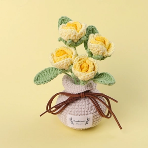 Detail of handmade crochet yellow roses in a cream vase with Handmade WITH LOVE label