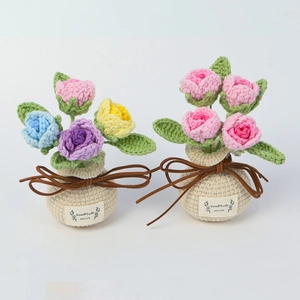 Detail of handmade crochet rose bouquets in knitted vases with Handmade WITH LOVE labels