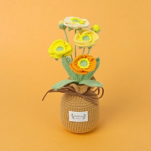 Handmade crochet gradient poppy in a knitted pot with 'Handmade With Love' tag