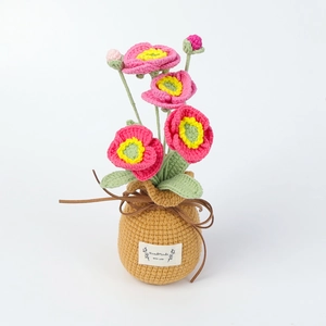 Detail of pink crochet poppy flowers in yellow vase with Handmade leather label
