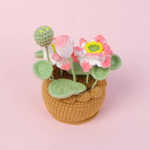 Handmade crochet lotus potted plant with pink flowers and green leaves home decoration