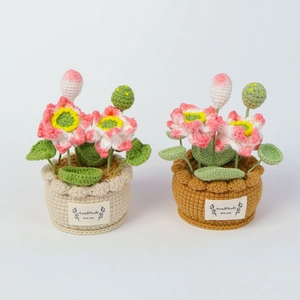 Detailed view of handmade crochet lotus potted plants with pink petals and green leaves
