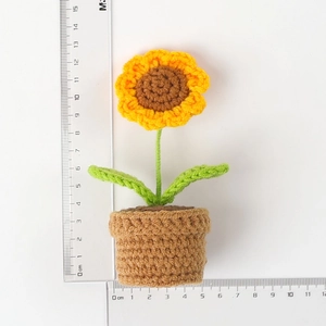 Handmade crochet sunflower plant in pot showing 12cm height measurement with a ruler