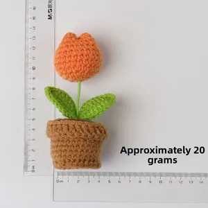 Handmade crochet orange tulip in brown pot with ruler measurement showing 14cm height