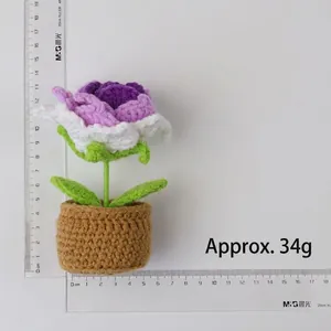 Handmade crochet rose potted plant in purple and pink tones with measuring ruler