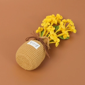Close-up of handmade crochet yellow honeysuckle potted flower with handmade label