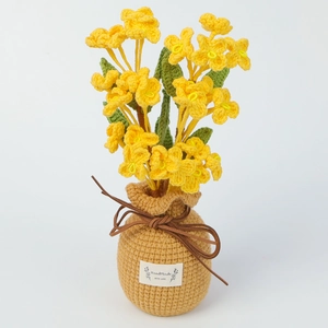 Detailed view of handmade crochet honeysuckle flower in a knitted pot with label