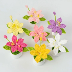 Top view of handmade crochet potted lilies in seven various vibrant colors on white background
