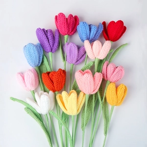 Close-up of handmade crochet tulip flowers in vibrant colors on a white background