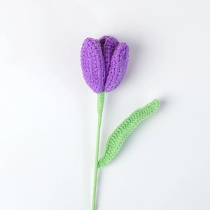 Detail showing the tight crochet texture and vivid purple yarn petals of the tulip flower