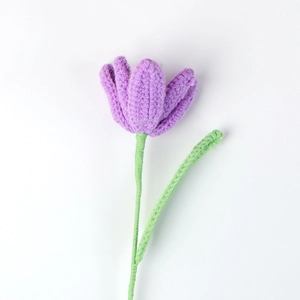 Detailed macro view of handcrafted purple crochet tulip with knitted wool texture