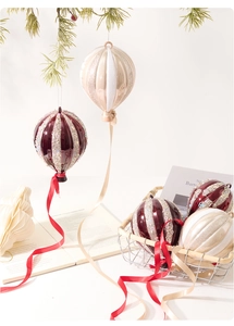 Detail of burgundy and champagne gold hot air balloon ornaments with glitter stripes