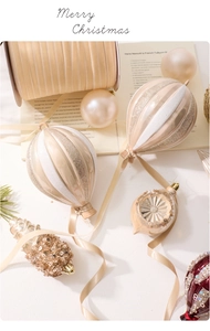 Detailed close-up of champagne gold hot air balloon ornaments and velvet ribbons
