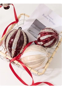 Close-up of red and cream Christmas ornaments with sequins in a metal basket