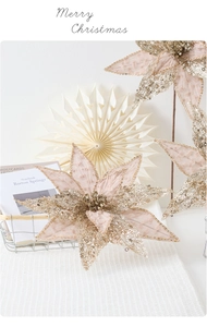 Champagne pink artificial Poinsettia with gold sequins on a stylish European style table
