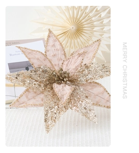 Close-up of pink artificial Christmas flower with gold sequins and beads texture