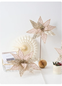 Detail view of handmade champagne gold sequined artificial poinsettia for holiday decor