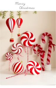 Detailed view of red and white striped Christmas tree ornaments with velvet bows and glitter