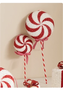 Detail of red and white glitter candy cane ornaments with striped ribbons for Christmas