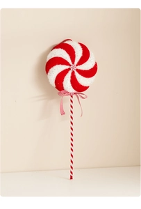 Detail of red and white Christmas lollipop ornament with glitter and a striped bow