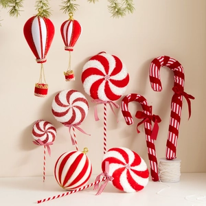 Festive red and white candy cane and lollipop Christmas ornaments with pine branch decor