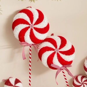 Red and white swirl Christmas lollipop tree pick with festive glitter and bow