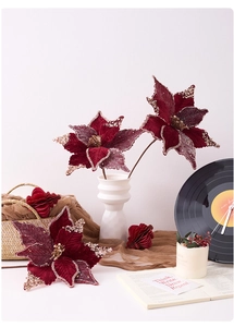 Red velvet Christmas poinsettia with gold glitter edges in a white wavy ceramic vase