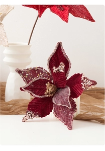 Detailed view of burgundy velvet poinsettia petals with champagne gold glitter edges