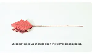 Detail of burgundy Christmas leaf decoration with gold edges and shipping instruction