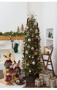 Cozy festive living room setup featuring a decorated Christmas tree and reindeer plush toys