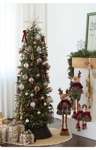 Detail of Christmas pencil tree decorated with gold stars and plush reindeer dolls