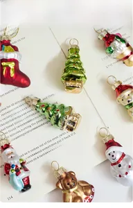 Flat lay of colorful miniature glass Christmas ornaments on a vintage magazine page