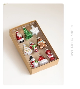 Detailed view of a 10-piece set of mini colorful glass Christmas ornaments in a kraft gift box