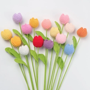 Detailed knit texture of handmade crochet tulip bouquet in vibrant assorted colors