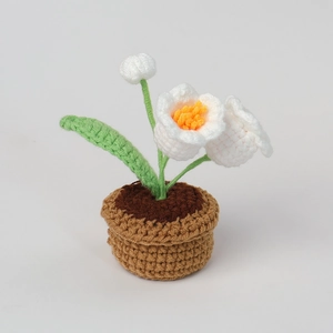 Handmade crochet lily of the valley potted plant with white flowers and green leaves